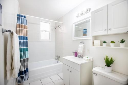 a white bathroom with a sink and a toilet at Historic Avenues Apartment Downtown in Salt Lake City