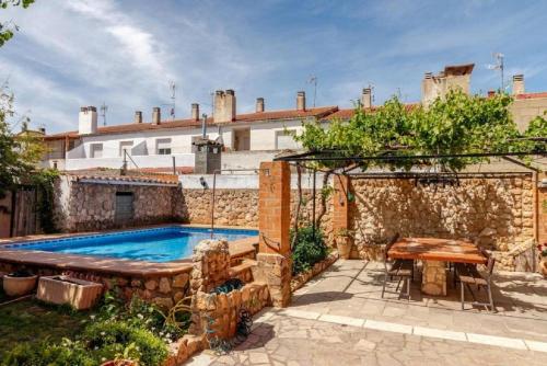 a house with a swimming pool and a table at Casa Rural La Casona in Casas de Juan Núñez