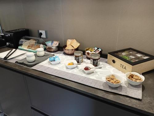 a table with bowls of food and a box on it at Casa Umeli with Jacuzzi and Sauna in Marsala