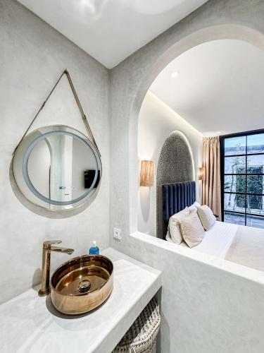 a bathroom with a sink and a bed and a mirror at La Finca - 3BR Seaside Villa with Private Pool & BBQ in Tangier