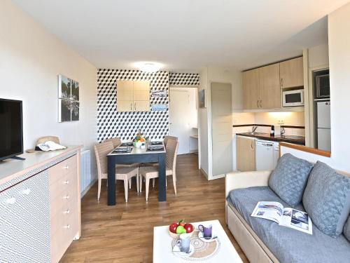 un salon et une cuisine avec un canapé et une table dans l'établissement Apartment Village Cap Estérel - Le Village-82 by Interhome, à Agay