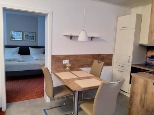 a kitchen and dining room with a table and chairs at Ferienhaus am Sonnenhang in Willingen