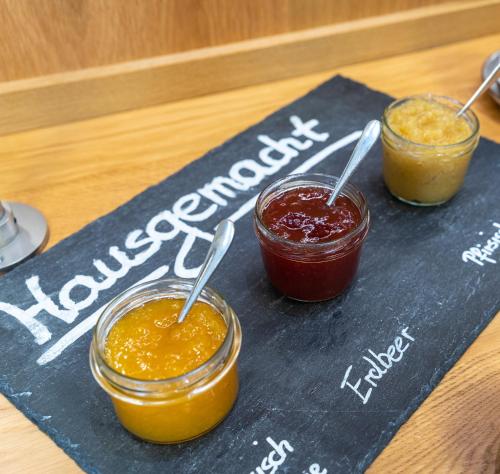 two jars of jam on a chalk board with a sign at Stadthotel Reich in Mellrichstadt