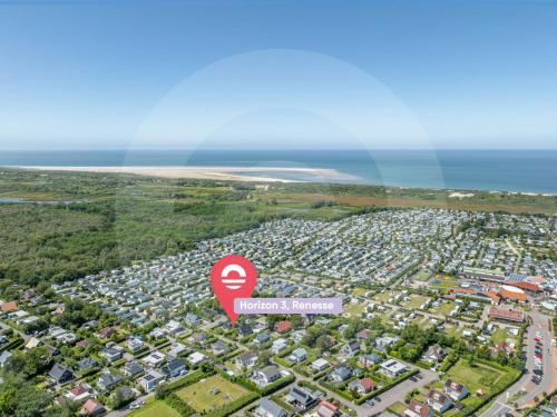 an aerial view of a city with houses and the ocean at Holiday Home Horizon by the Sea by Interhome in Renesse