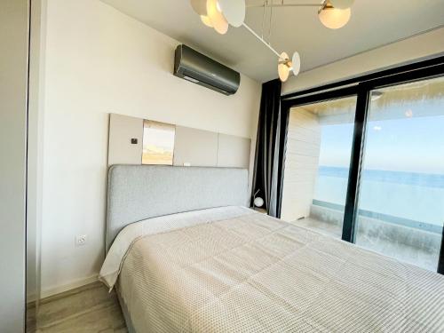 a bedroom with a bed and a large window at Apartment Villa Škoda by Interhome in Povljana