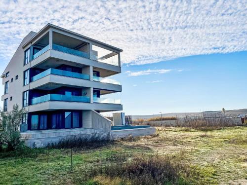 a building on the side of a hill with a field at Apartment Villa Škoda by Interhome in Povljana