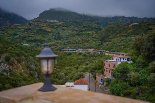 a street light on top of a building on a mountain at appartements Al Amri akchour in Chefchaouene