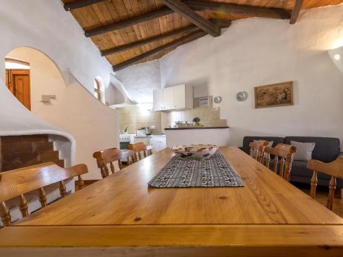a kitchen and dining room with a wooden table at Holiday Home Doria by Interhome in La Ciaccia