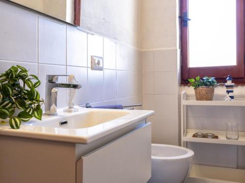 a bathroom with a sink and a toilet at Holiday Home Doria by Interhome in La Ciaccia
