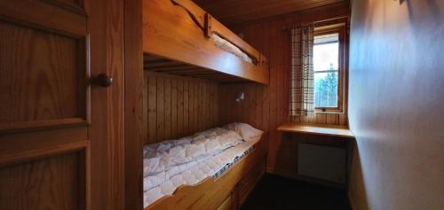 an empty bunk bed in a room with a window at Sauna | Wi-Fi | Terrace | Wood stove | Cable TV in Lofsdalen