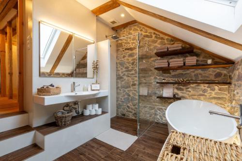 a bathroom with a sink and a glass shower at Living on a animal sanctuary in Schönenberg