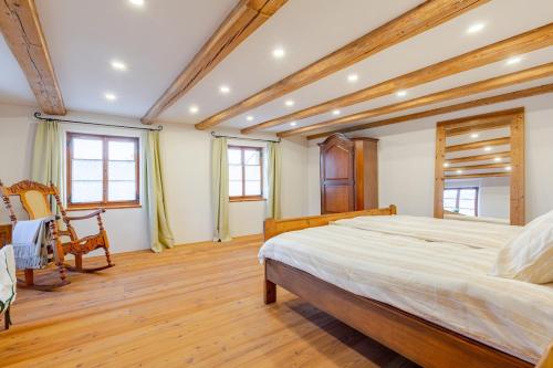 a large bedroom with a large bed and wooden floors at Living on a animal sanctuary in Schönenberg