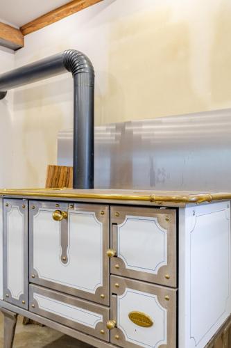 a stove with a pipe on top of a counter at Living on a animal sanctuary in Schönenberg