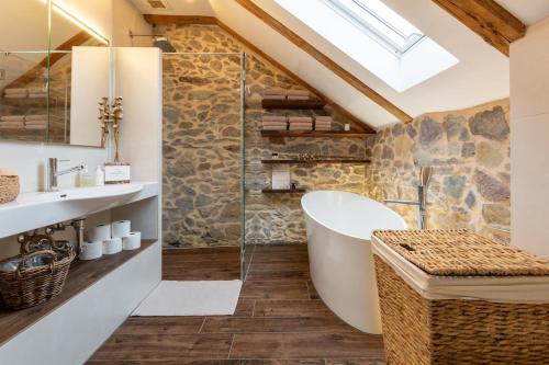 a bathroom with a tub and a glass shower at Living on a animal sanctuary in Schönenberg