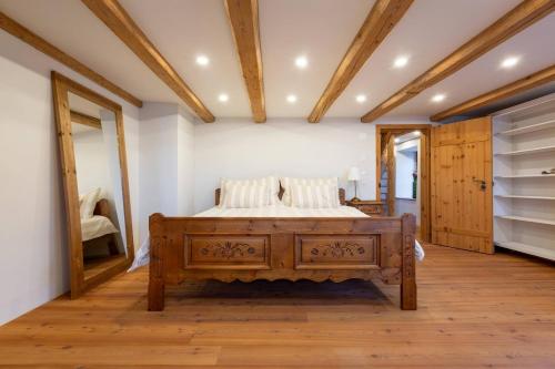 a bedroom with a bed in a room with wooden floors at Living on a animal sanctuary in Schönenberg