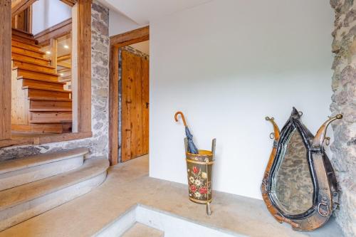 two umbrellas sitting on a wall in a room at Living on a animal sanctuary in Schönenberg