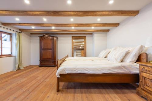 a bedroom with a large bed and a wooden dresser at Living on a animal sanctuary in Schönenberg