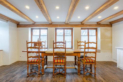 a dining room with a wooden table and chairs at Living on a animal sanctuary in Schönenberg