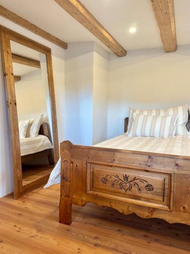 a bedroom with a bed and a mirror at Living on a animal sanctuary in Schönenberg