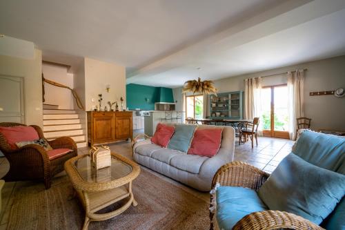 a living room with a couch and chairs and a table at La Petite Toscane en Beaujolais in Saint-Vérand