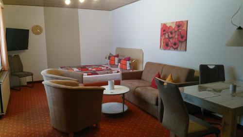 a living room with a couch and a table at Ferienhaus am Sonnenhang in Willingen