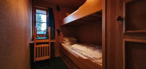 a small bedroom with a bunk bed in a cabin at Sauna | Wi-Fi | Terrace | Wood stove | Cable TV in Lofsdalen