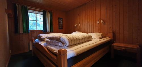 a bedroom with a bed in a room with a window at Sauna | Wi-Fi | Terrace | Wood stove | Cable TV in Lofsdalen