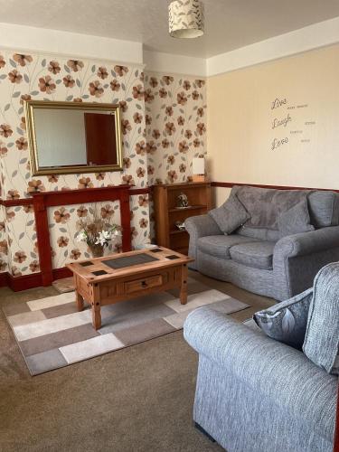 a living room with a couch and a coffee table at Shirleys apartment in Rhyl