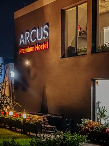 a sign on the side of a building with a bench at Arcus Premium Hostel in Warsaw