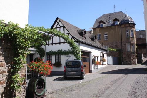 a car parked in a street next to a building at Weinhaus Hirschen Bruttig in Bruttig-Fankel