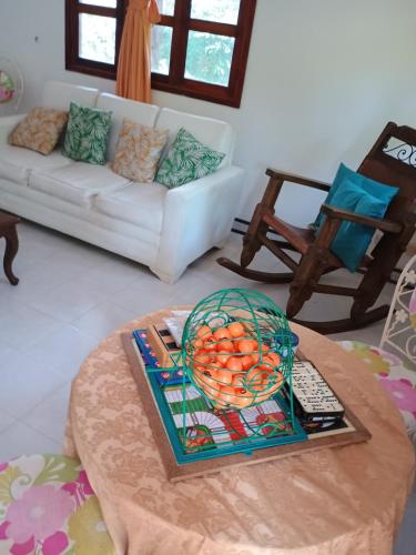 a living room with a bowl of fruit on a table at Ecopolis hospedajes casa de campo tradicional in Papagalleros