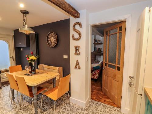 a dining room with a wooden table and chairs at Seahaven in Maryport
