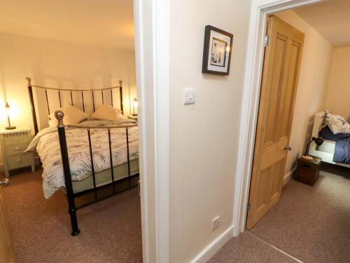 a bedroom with a bed and a door to a room at Seahaven in Maryport