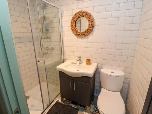 a bathroom with a toilet and a sink and a shower at Seahaven in Maryport
