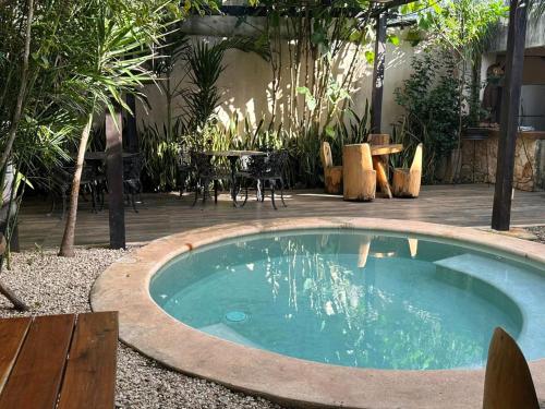 a small pool in a yard with a table and chairs at Casa la Roca Valladolid in Valladolid
