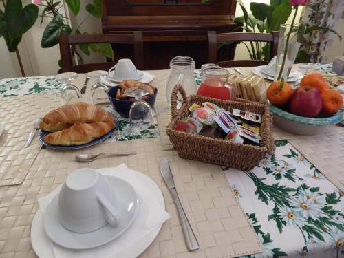 a table with a plate of food and a basket of fruit at B&B Al Santo in Padova