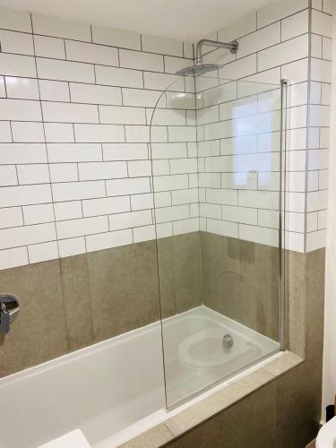 a bathroom with a shower with a tub at Le jardin 211 in George