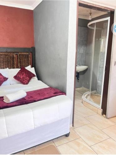 Ένα ή περισσότερα κρεβάτια σε δωμάτιο στο MD Guesthouse Debruin park
