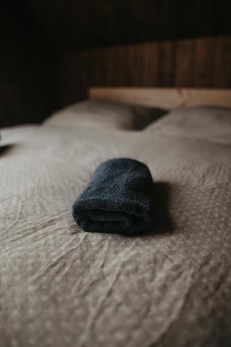 a blue towel is sitting on a bed at Bobrí potôčik in Liptovský Mikuláš
