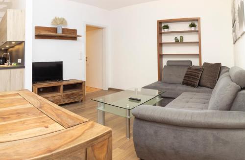 a living room with a couch and a table at Apartmenthaus ROSE in Prutz