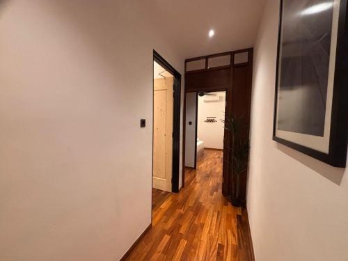 a hallway with a hallway leading to a room at Carnarvon Suites in George Town