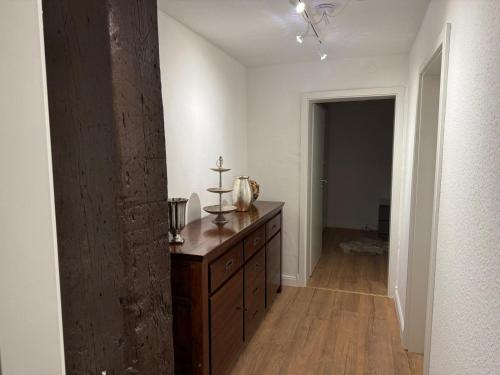 a hallway with a wooden dresser in a room at Ferienwohnung Seegat in Emden
