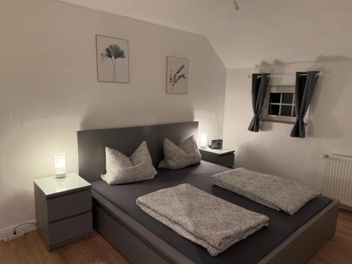 a bedroom with a bed with two pillows on it at Ferienwohnung Seegat in Emden