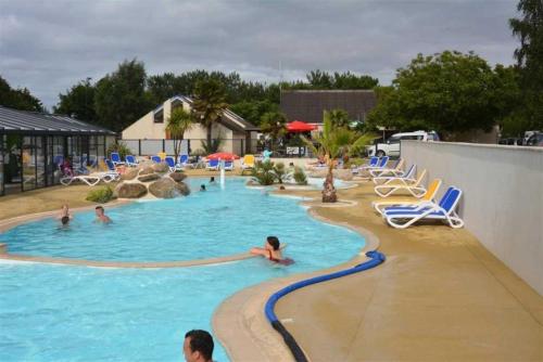 a group of people in a pool at a resort at ZEcamping 4 étoiles animé parc aquatique pet friendly sauna in Saint-Lunaire