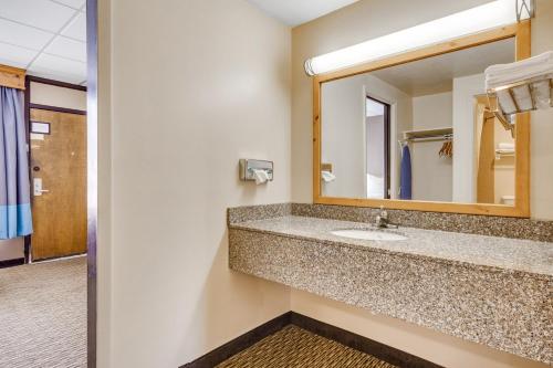 a bathroom with a sink and a mirror at Best Western Lee's Motor Inn in Chamberlain