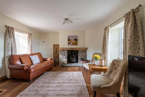 a living room with a couch and a fireplace at Vauxhall Cottage, Chepstow - 4 Bedroom Pet-Friendly Home with Private Fenced Garden, Walk to Town and Castle in Chepstow
