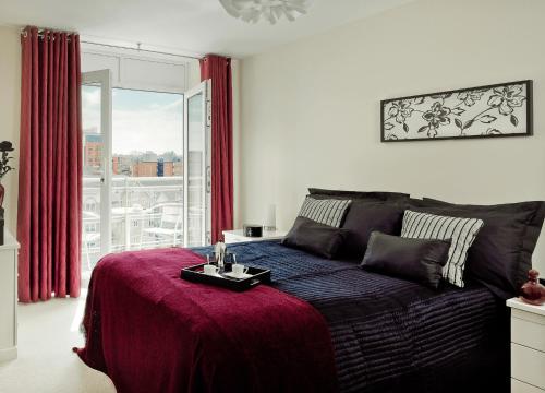 a bedroom with a bed with a table on it at Reading Spacious Two Bedroom Apartment in Reading