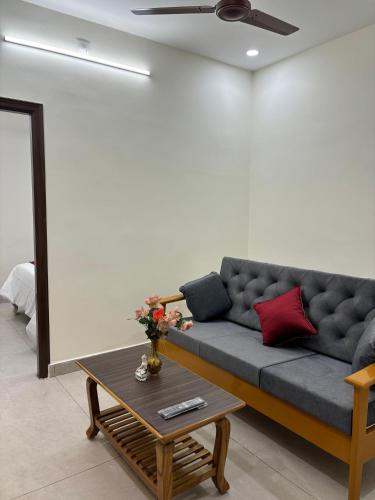 a living room with a couch and a coffee table at PS Elite Homestay in Tirupati