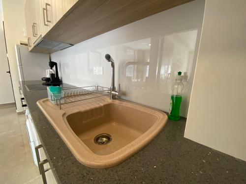a large sink in a kitchen with aaucet at Seaside Luxury Flat in Harbour Tourist Area in Paphos City