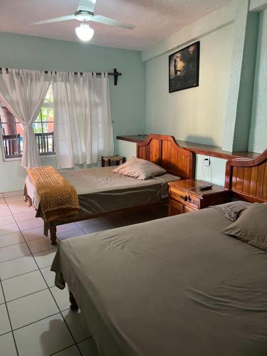 Tempat tidur dalam kamar di Hotel Casa Corita